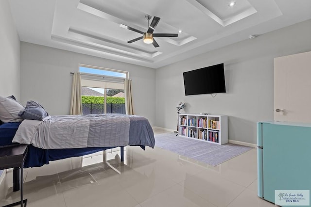 5483 Lovers Ln, Brownsville, TX 78526 - tiled bedroom featuring a raised ceiling, freestanding refrigerator, access to outside, a ceiling fan, and recessed lighting