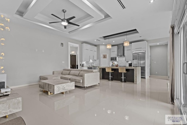 5483 Lovers Ln, Brownsville, TX 78526 - living room featuring a raised ceiling, light tile patterned flooring, and ceiling fan