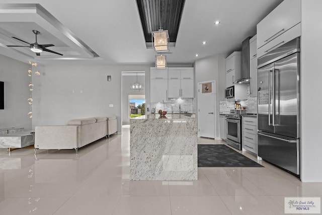 5483 Lovers Ln, Brownsville, TX 78526 - kitchen featuring stainless steel appliances, open floor plan, backsplash, ceiling fan, and light tile patterned flooring