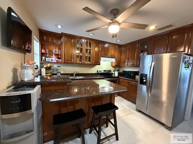 2100 W San Marcelo Blvd Unit 216, Brownsville, TX 78526 - kitchen with appliances with stainless steel finishes, under cabinet range hood, a peninsula, recessed lighting, and glass insert cabinets