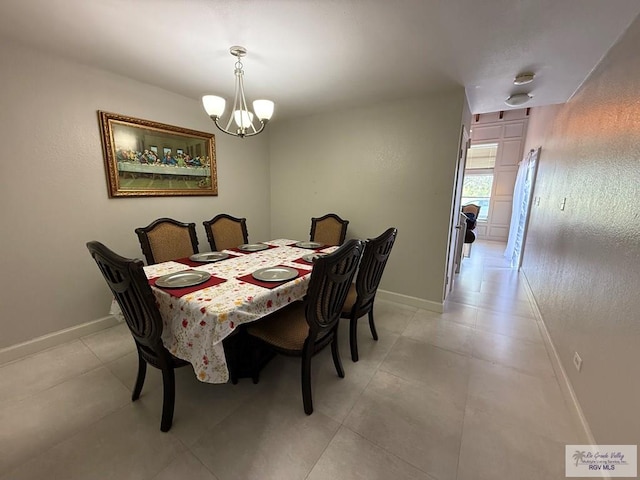 2100 W San Marcelo Blvd Unit 216, Brownsville, TX 78526 - dining space featuring a chandelier and baseboards