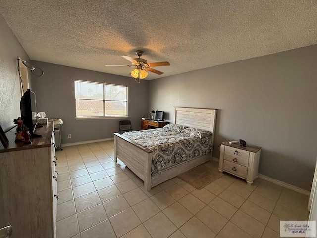 2100 W San Marcelo Blvd Unit 216, Brownsville, TX 78526 - bedroom with light tile patterned floors, a textured ceiling, ceiling fan, baseboards, and an office area