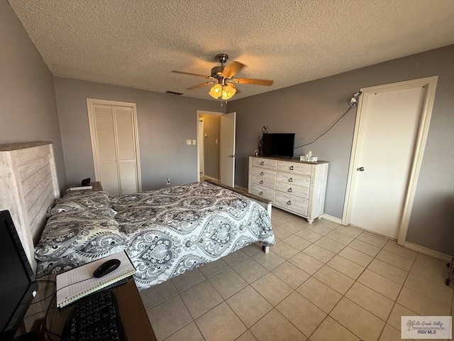 2100 W San Marcelo Blvd Unit 216, Brownsville, TX 78526 - bedroom with light tile patterned flooring, a textured ceiling, a closet, and ceiling fan