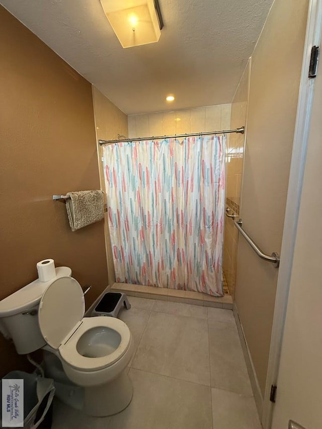 2100 W San Marcelo Blvd Unit 216, Brownsville, TX 78526 - full bathroom with toilet, a shower with shower curtain, tile patterned flooring, and baseboards