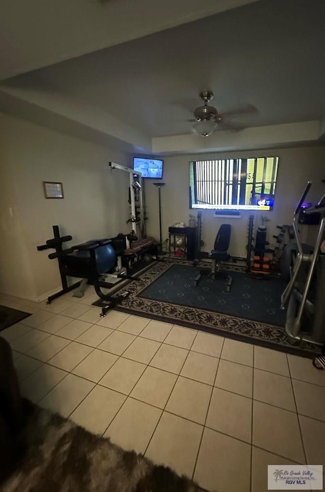 workout room with light tile patterned floors and ceiling fan