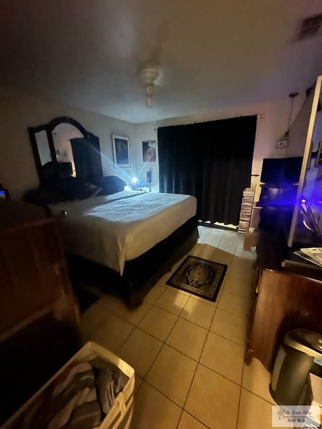 bedroom with light tile patterned floors