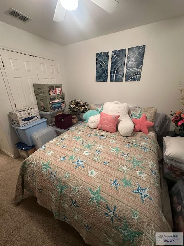 carpeted bedroom with a closet and ceiling fan