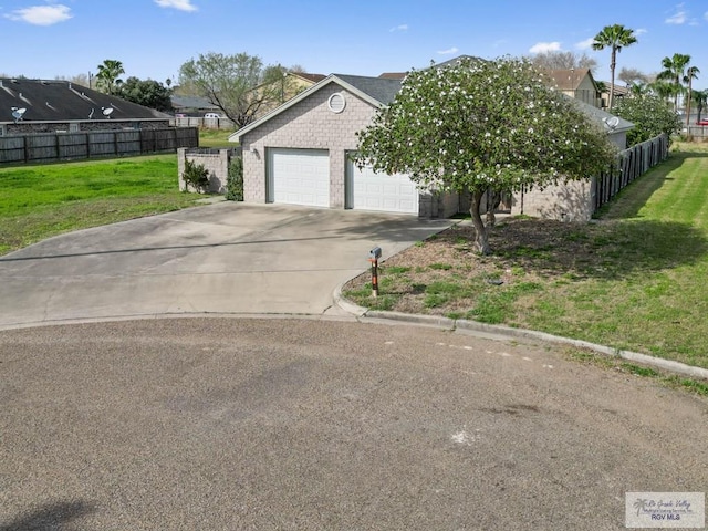 view of front of house with a garage and a front lawn