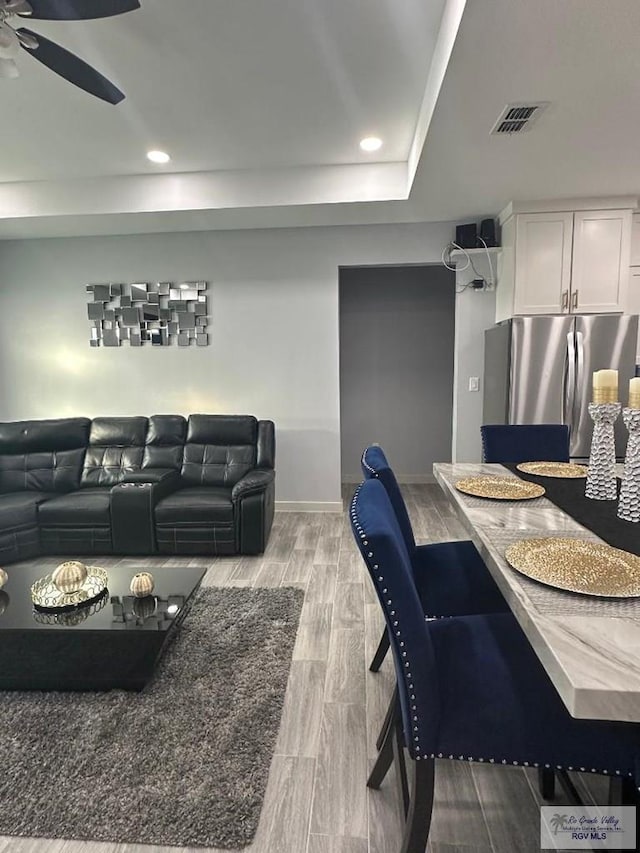 interior space featuring a tray ceiling and ceiling fan