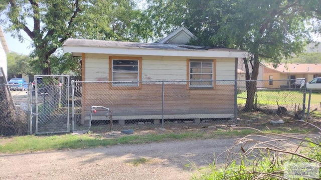 view of home's exterior featuring a gate and fence