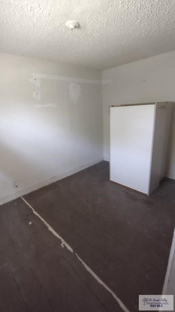 spare room with a textured ceiling
