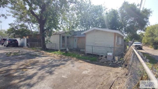 exterior space featuring driveway and fence
