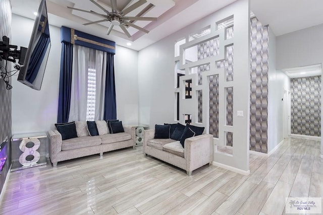 living room featuring ceiling fan and light wood-type flooring