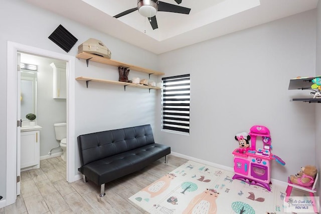 playroom with ceiling fan and light hardwood / wood-style floors