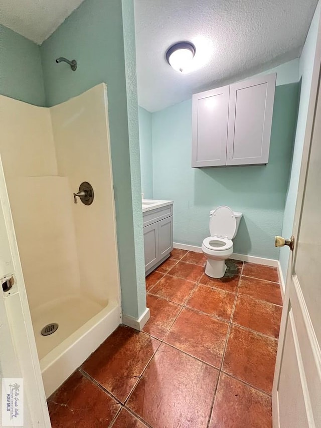 bathroom featuring walk in shower, tile patterned floors, a textured ceiling, toilet, and vanity