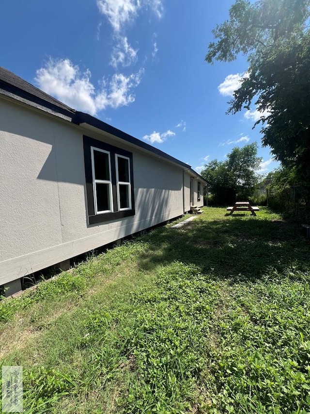 view of property exterior with a lawn