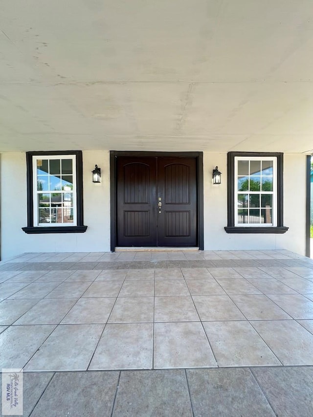 view of exterior entry featuring a porch