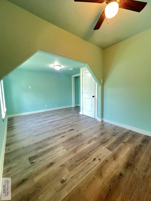 additional living space with hardwood / wood-style floors and ceiling fan