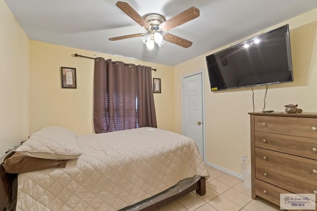 tiled bedroom with ceiling fan