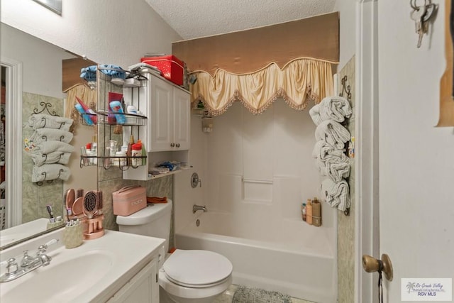 full bathroom featuring vanity, toilet, a textured ceiling, and bathtub / shower combination