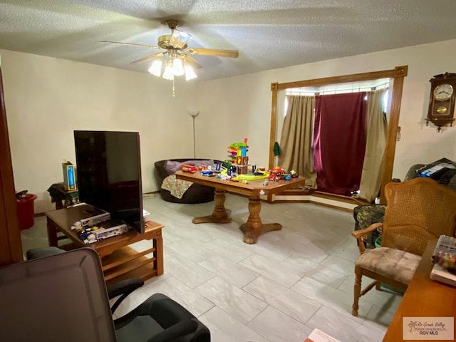 game room featuring a textured ceiling and ceiling fan