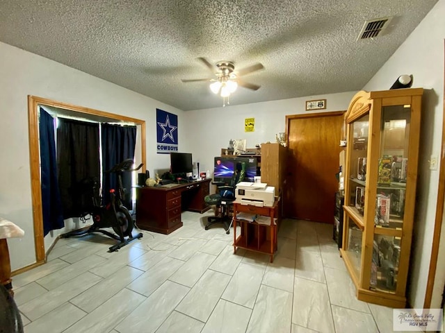 office space featuring ceiling fan and a textured ceiling