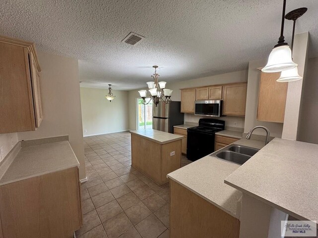 1072 Vamonos Dr, Brownsville, TX 78526 - kitchen featuring appliances with stainless steel finishes, a sink, light brown cabinetry, a center island, and light countertops