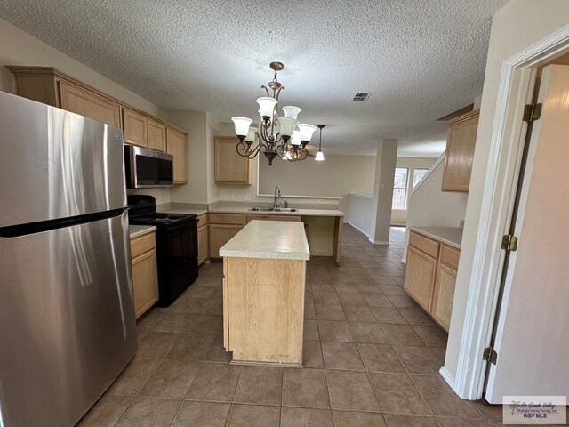 1072 Vamonos Dr, Brownsville, TX 78526 - kitchen featuring appliances with stainless steel finishes, a sink, a peninsula, light countertops, and a chandelier