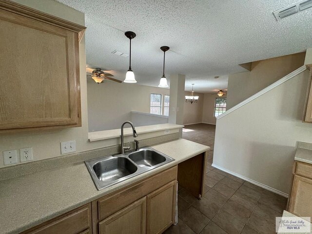 1072 Vamonos Dr, Brownsville, TX 78526 - kitchen with a sink, a chandelier, hanging light fixtures, ceiling fan, and dark tile patterned flooring