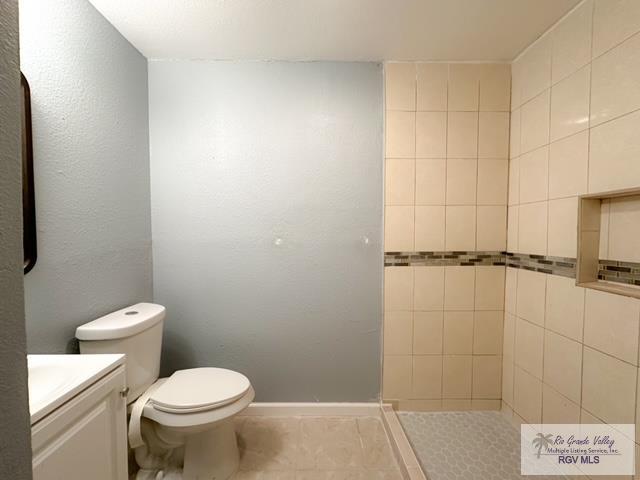 bathroom featuring tile patterned floors, vanity, and toilet