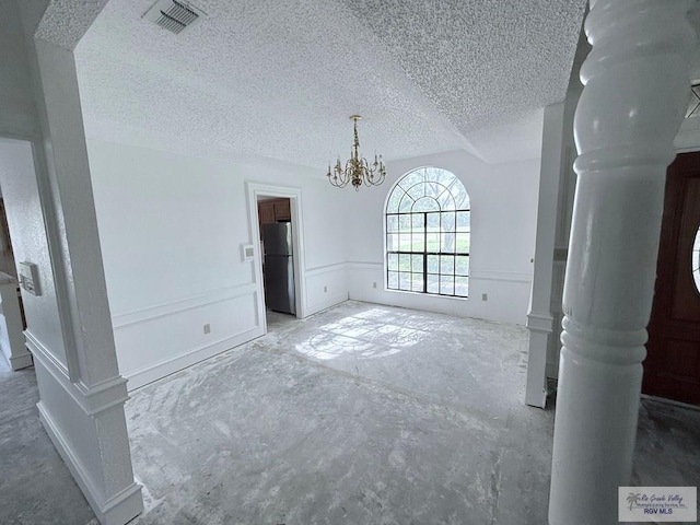 unfurnished living room featuring a textured ceiling and an inviting chandelier