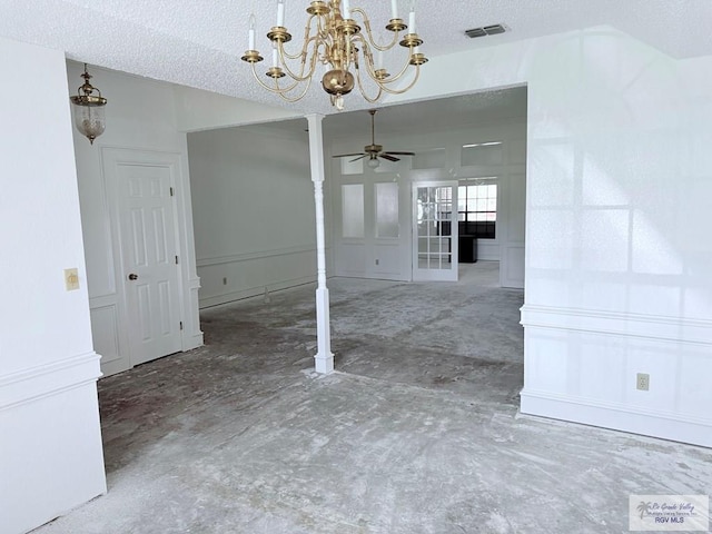 unfurnished dining area with a textured ceiling and ceiling fan with notable chandelier