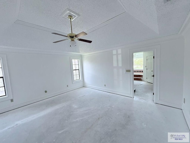 spare room featuring a wealth of natural light, ceiling fan, and a textured ceiling