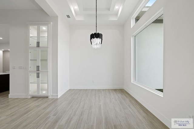 119 Finch Dr, Los Fresnos, TX 78566 - unfurnished dining area featuring baseboards, a notable chandelier, light wood-style flooring, and visible vents