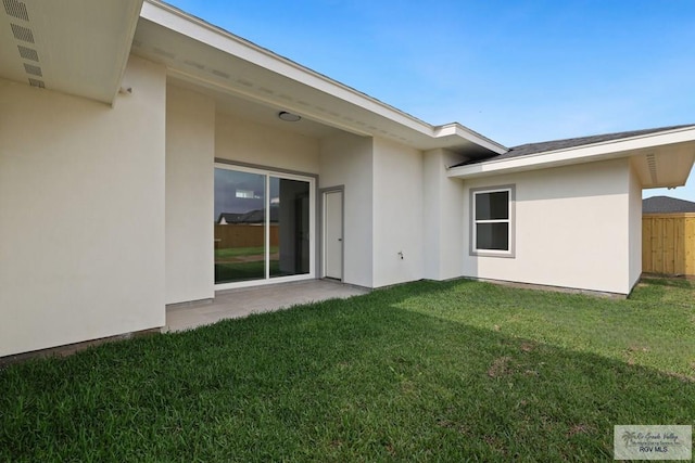 119 Finch Dr, Los Fresnos, TX 78566 - rear view of house featuring stucco siding and a yard