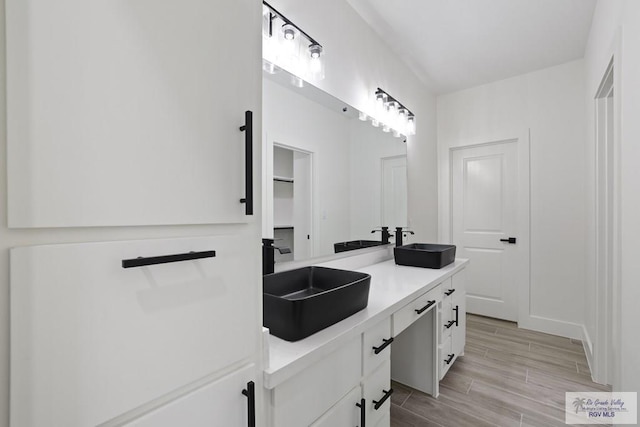 119 Finch Dr, Los Fresnos, TX 78566 - full bathroom featuring double vanity, a sink, and wood tiled floor
