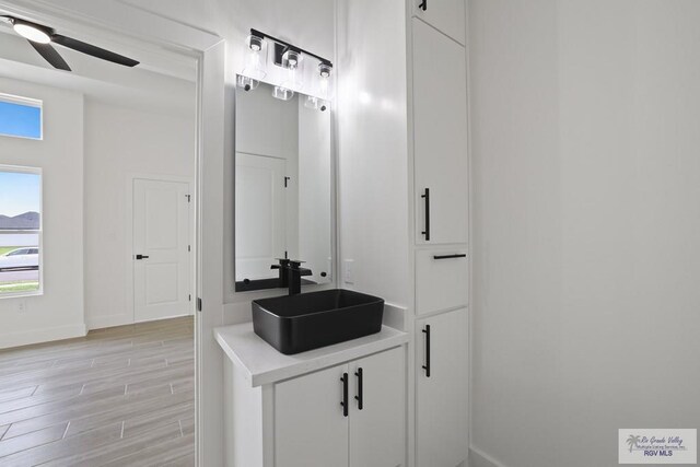 119 Finch Dr, Los Fresnos, TX 78566 - bathroom featuring baseboards, ceiling fan, vanity, and wood finished floors