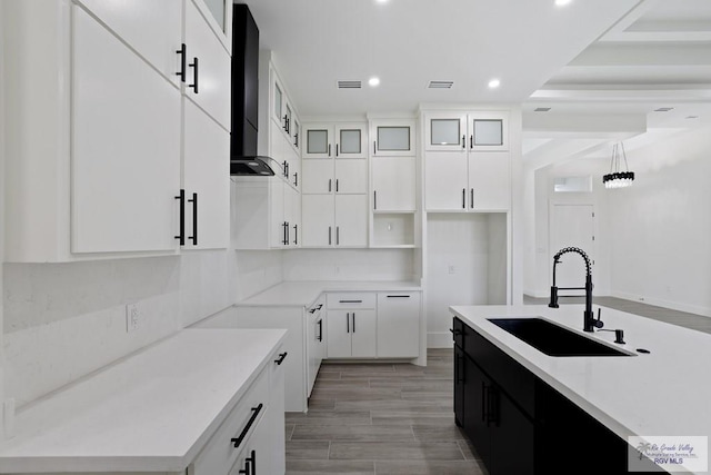 119 Finch Dr, Los Fresnos, TX 78566 - kitchen featuring visible vents, white cabinetry, a sink, recessed lighting, and wall chimney exhaust hood