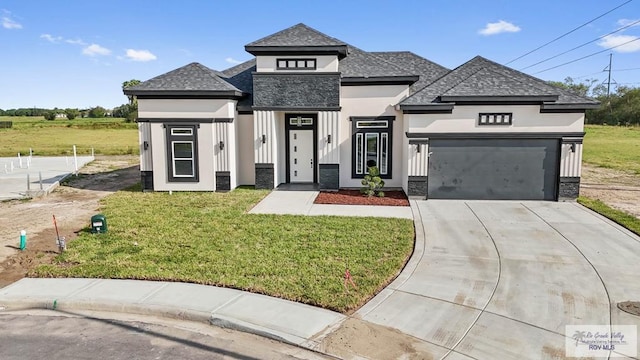 prairie-style house with a front yard and a garage