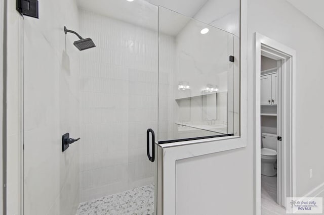 bathroom with an enclosed shower and toilet