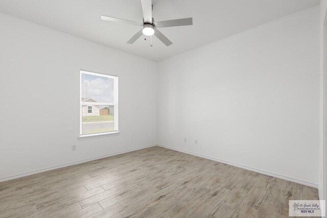 spare room featuring ceiling fan and light hardwood / wood-style flooring