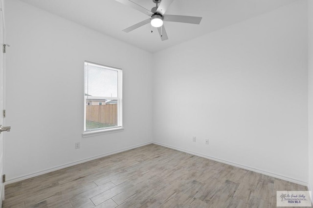 spare room with ceiling fan and light wood-type flooring