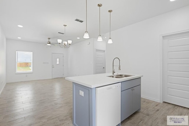 kitchen with pendant lighting, a kitchen island with sink, white dishwasher, sink, and light hardwood / wood-style floors