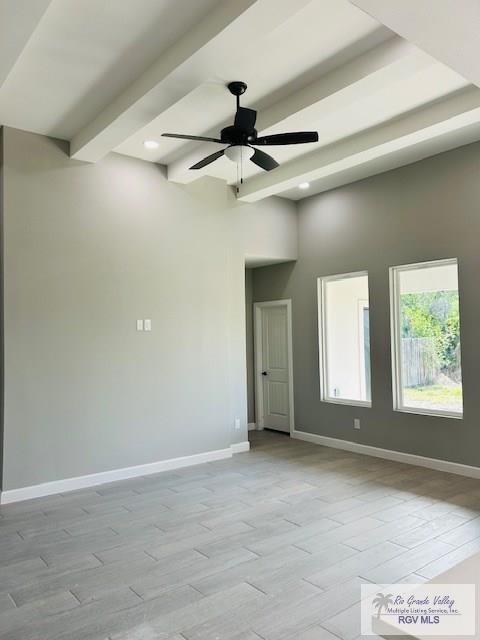 521 Valley Oak Cir, Los Fresnos, TX 78566 - spare room with baseboards, ceiling fan, wood finished floors, beamed ceiling, and recessed lighting