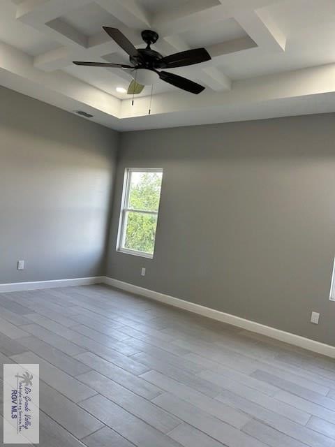 521 Valley Oak Cir, Los Fresnos, TX 78566 - unfurnished room featuring coffered ceiling, baseboards, beamed ceiling, ceiling fan, and wood finished floors