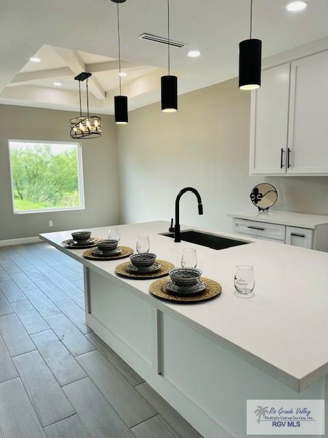 521 Valley Oak Cir, Los Fresnos, TX 78566 - kitchen featuring a sink, recessed lighting, white cabinetry, light countertops, and coffered ceiling