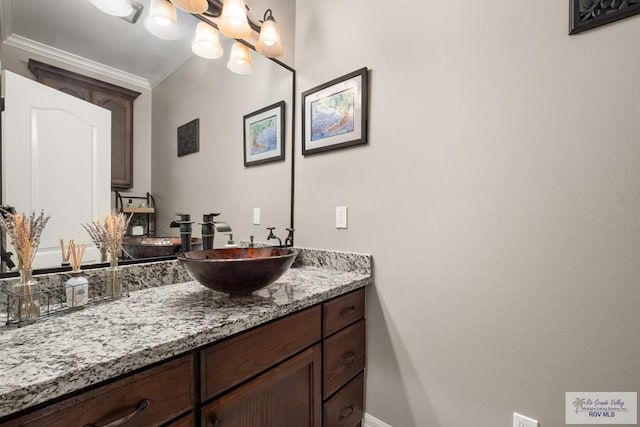 bathroom featuring ornamental molding and vanity