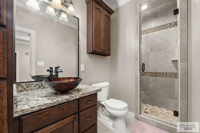 bathroom with a shower with shower door, vanity, toilet, crown molding, and tile patterned floors