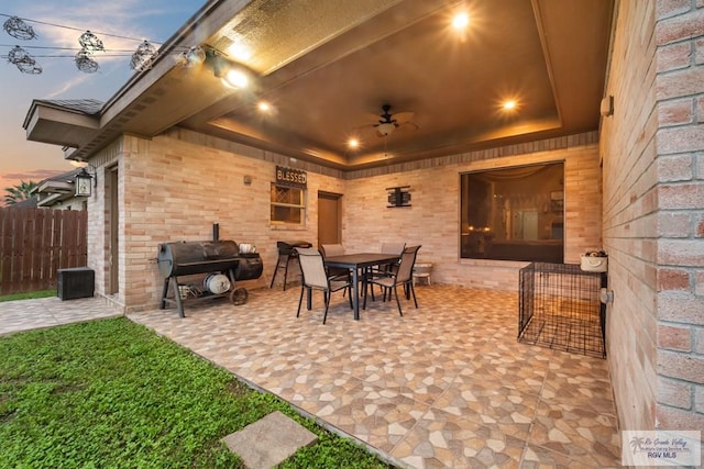 patio terrace at dusk featuring ceiling fan