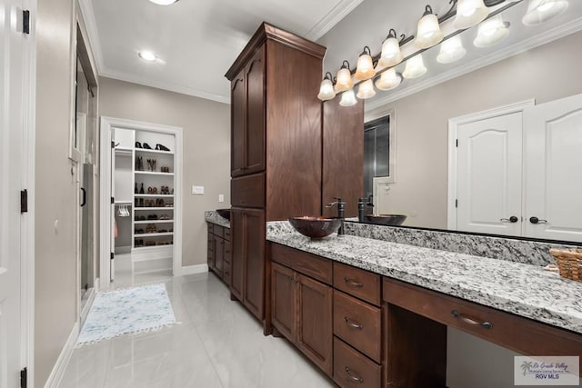 bathroom featuring crown molding and vanity